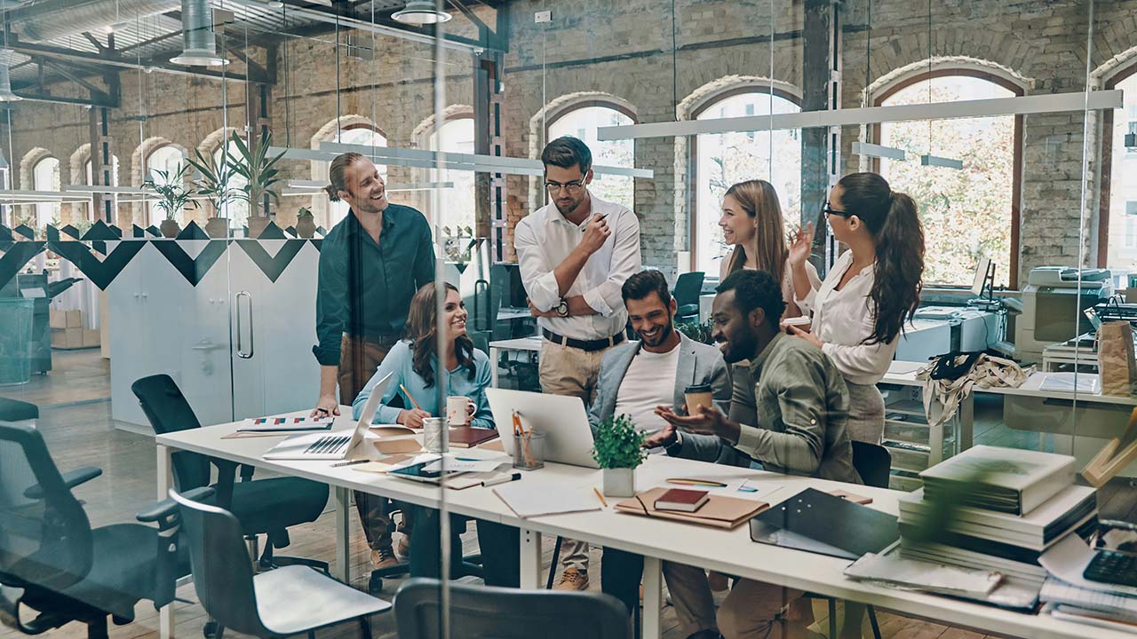 Employees working together at large table.